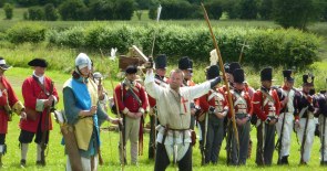 The archers show off their bows while redcoats wait their turn.